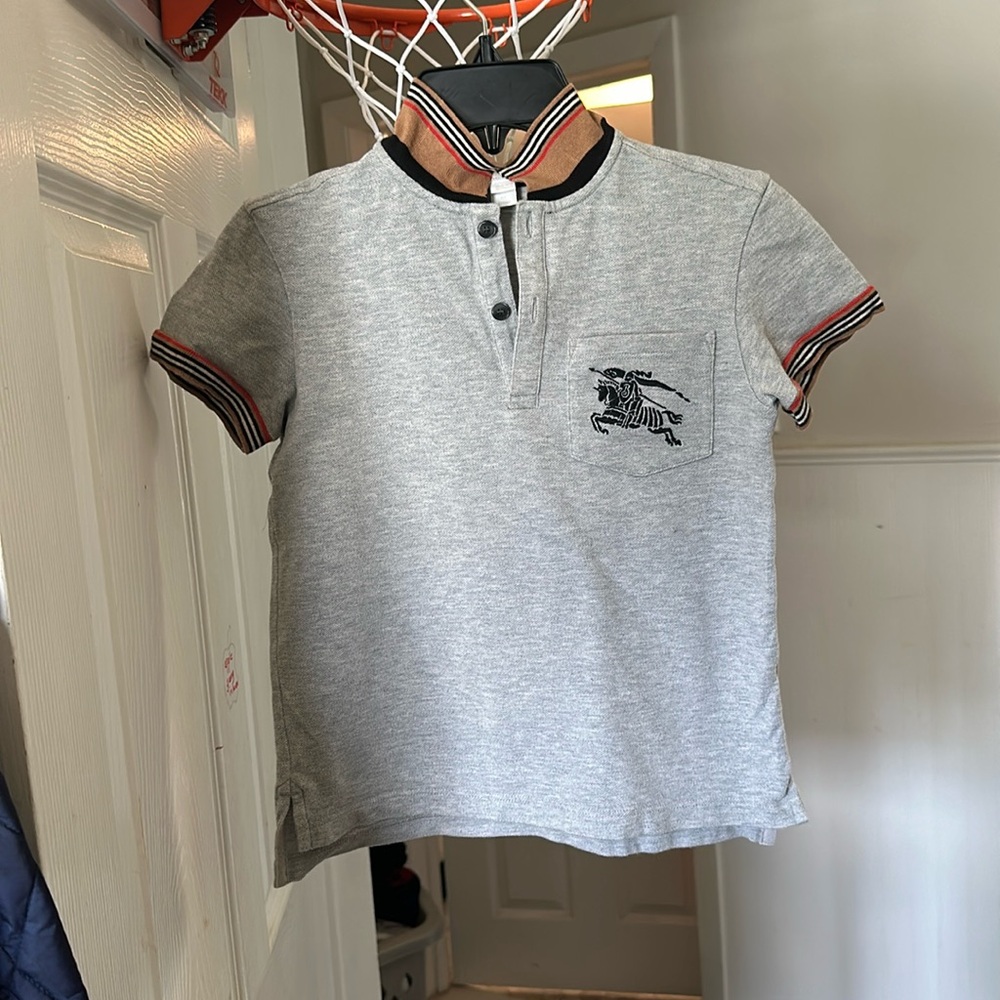 This a authentic Burberry polo style shirt size 8silver and tan.
